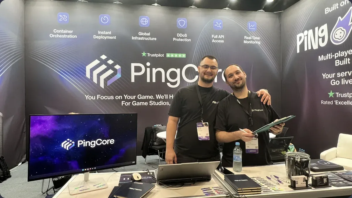 Two of the team at the stand desk at Gamescom 2026 in Cologne