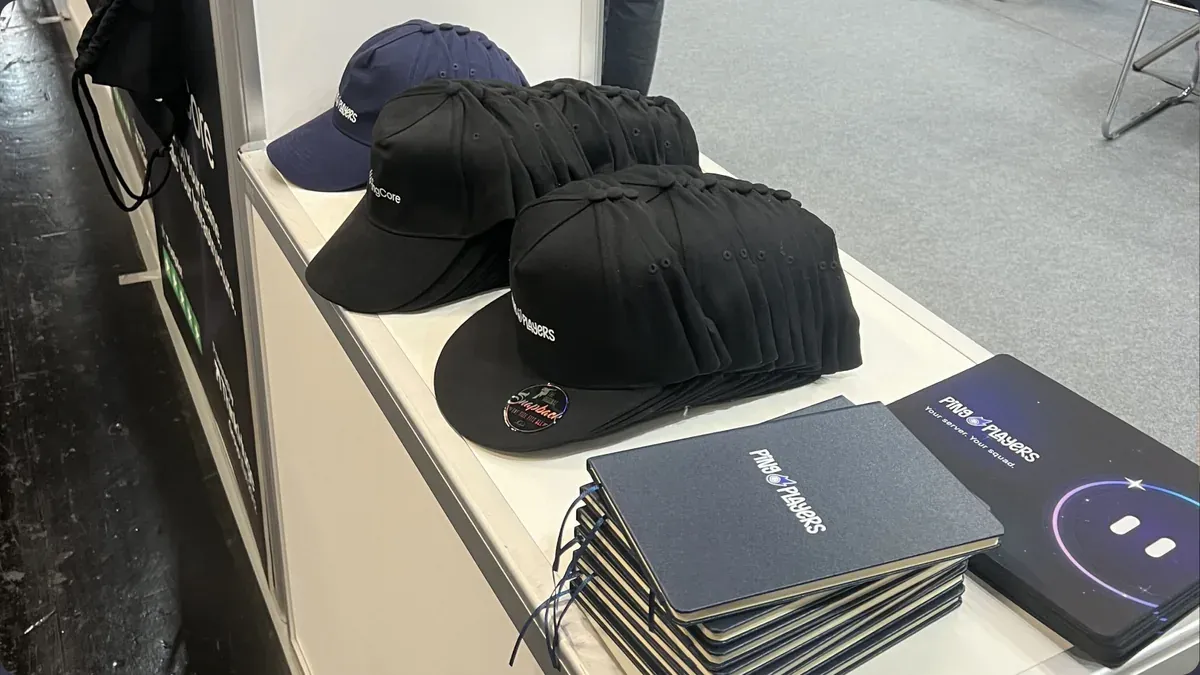 PingPlayers caps and notebooks on the stand table at Gamescom 2026 in Cologne