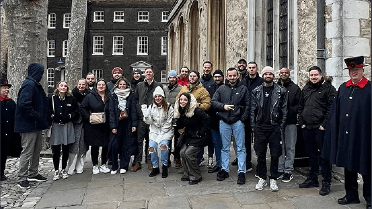 A large group of the team in winter coats at the Tower of London